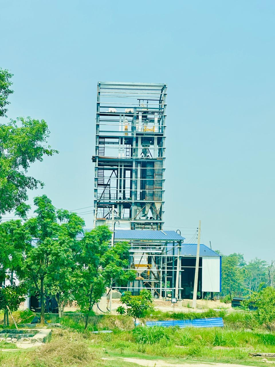 National Feed and Food processing plant with a tall steel feed mill tower in Nepal.